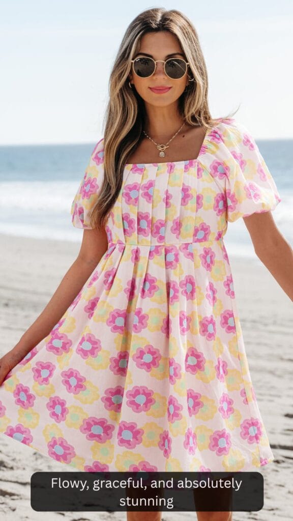 Woman wearing a stylish Alessandra pleated flared midi dress for a summer event.