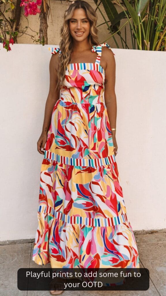 A woman wearing the Milan striped trim maxi sundress, styled for a sunny day out by the beach or a summer brunch.