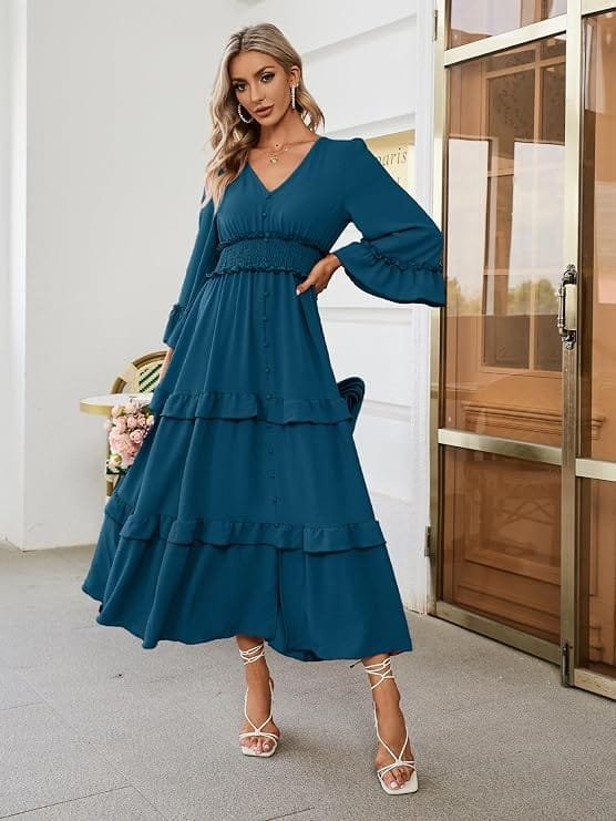 Best Summer Dresses 2026 You Need in Your Wardrobe 7 A model wearing the Amegoya Women's V Neck Long Sleeve Boho Maxi Dress in lake blue featuring a V-neckline, long bell sleeves, and a tiered ruffle skirt for warm-weather fashion.