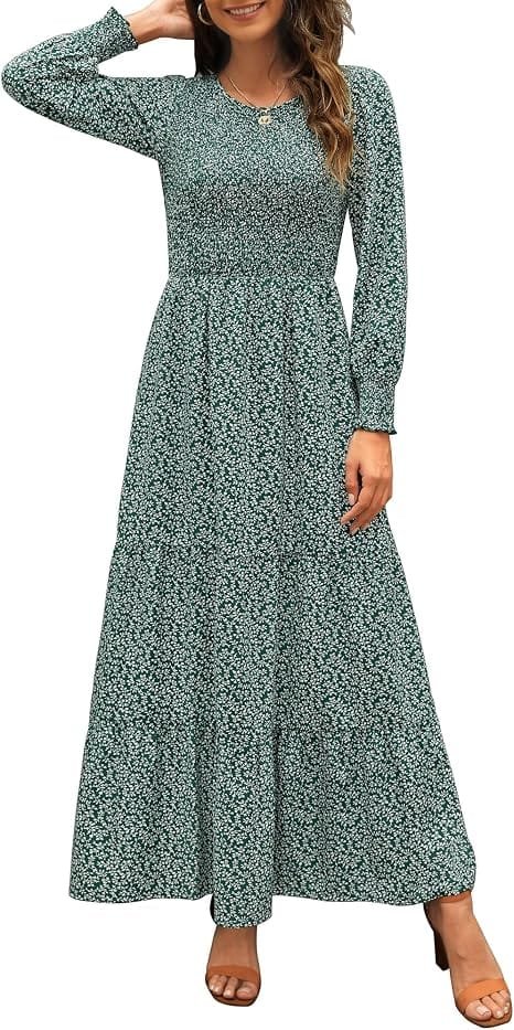A stylish woman modeling a green Annebouti Women's 2026 Spring Casual Long Sleeve Maxi Dress with a smocked bodice and tiered floral skirt while standing against a neutral background.