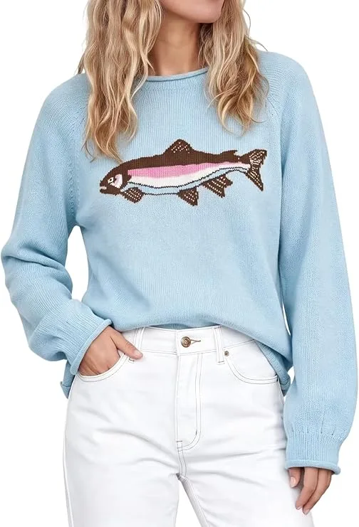 A fashion model wearing the pastel blue aswulk Women Cute Animal Graphic Long Sleeve Pullover Sweater with white pants, showcasing a trendy fall casual aesthetics outfit.
