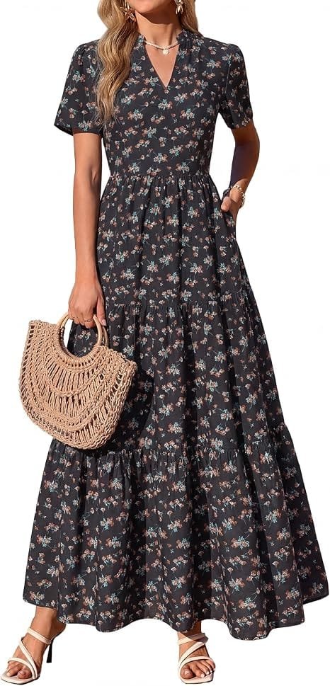 Best Summer Dresses 2026 You Need in Your Wardrobe 6 A model showcasing the KIRUNDO Womens Floral Boho Flowy Maxi Dress in black and yellow floral print, featuring short sleeves and a tiered swing skirt for warm-weather fashion.