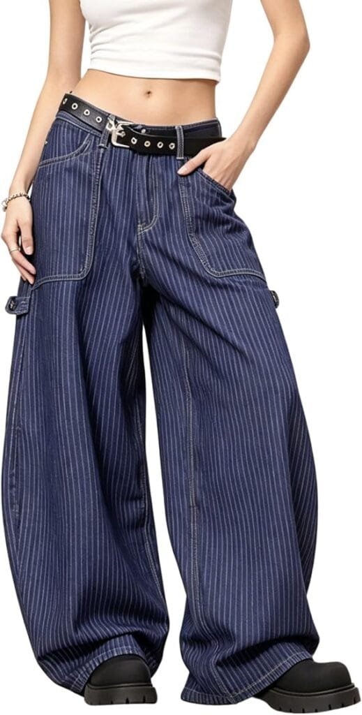 A young woman wearing trendy PEAINJ striped high-waisted baggy barrel jeans paired with a plain white t-shirt and belt, showcasing a vintage 2000s Y2K aesthetic outfit while standing on a suburban sidewalk.