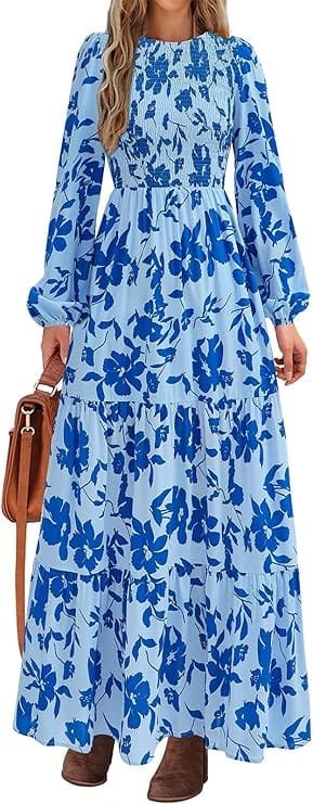 Best Summer Dresses 2026 You Need in Your Wardrobe 11 A model wearing the PRETTYGARDEN Women's Fall Dresses 2026 Long Sleeve Flowy Casual Floral Maxi Dress in light blue floral, featuring a smocked bodice, crewneck, and long puff sleeves for warm-weather fashion.