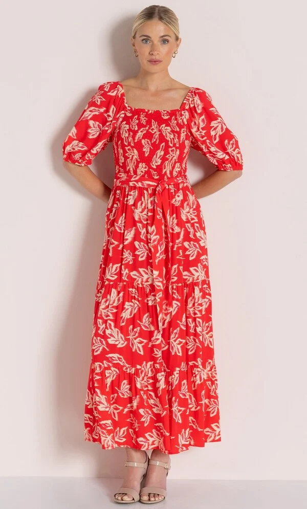 15 Stunning Trendy Summer Dresses Ideas To Elevate Your Style In 2026 7 A model showcasing the red and ecru Printed Short Puff Sleeve Maxi Dress with a square neckline and puff sleeves, styled for summer wear.