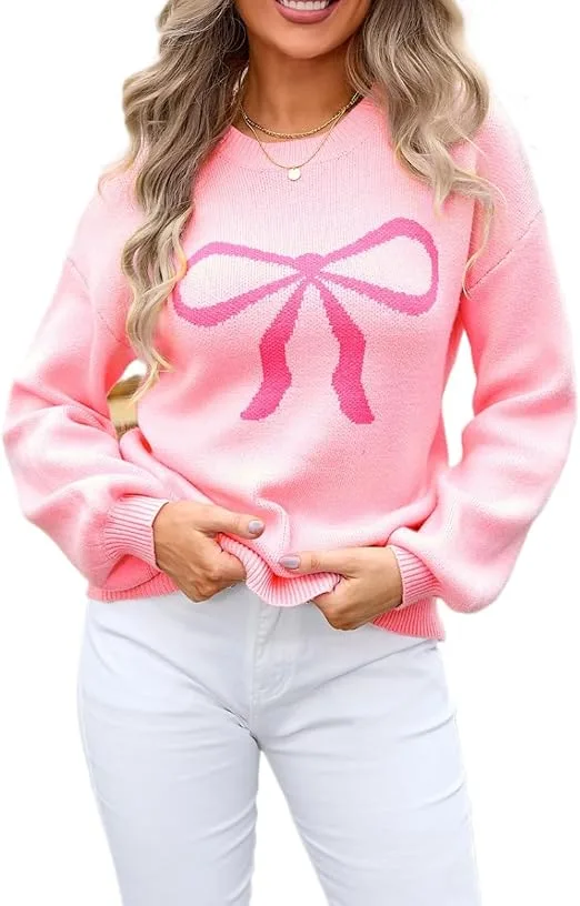 A fashion model wearing the pink Sumleno Womens Fall Winter Casual Sweater Cute Bow Crewneck Long Sleeve Baggy Knit Sweatshirt Top Trendy Aesthetic Clothes styled with white jeans, perfect for showcasing a sweet fall casual aesthetics outfit.