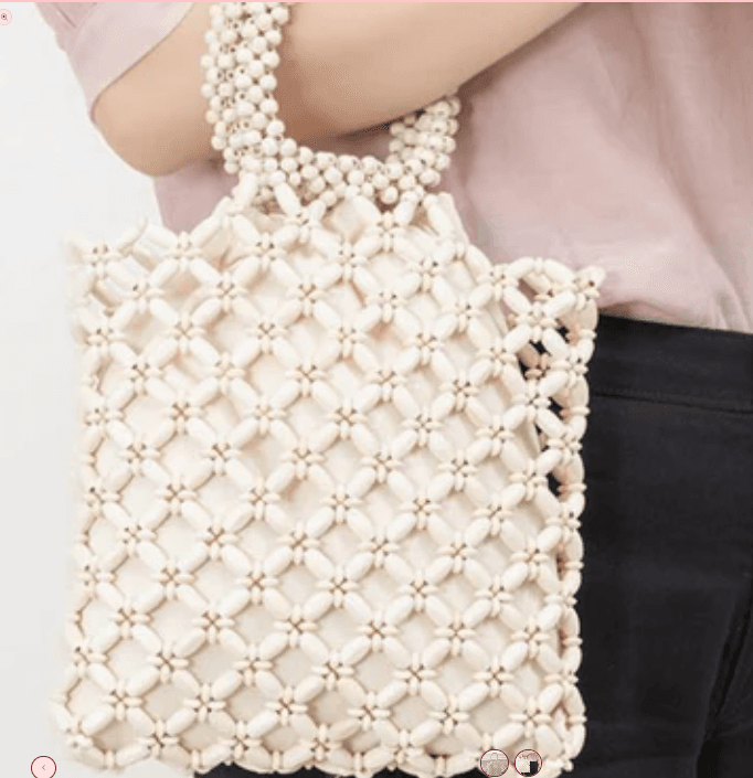 A Mure & Grand wooden bead contrast color handbag styled for a 2026 summer capsule wardrobe.