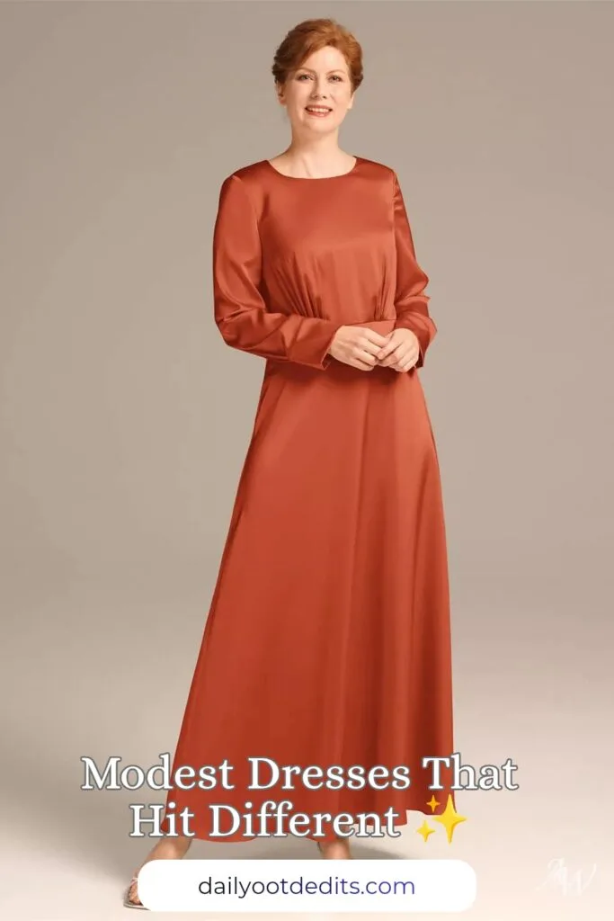 A floor-length modest formal dress in vibrant tangerine satin charmeuse, perfect for formal summer events and weddings.