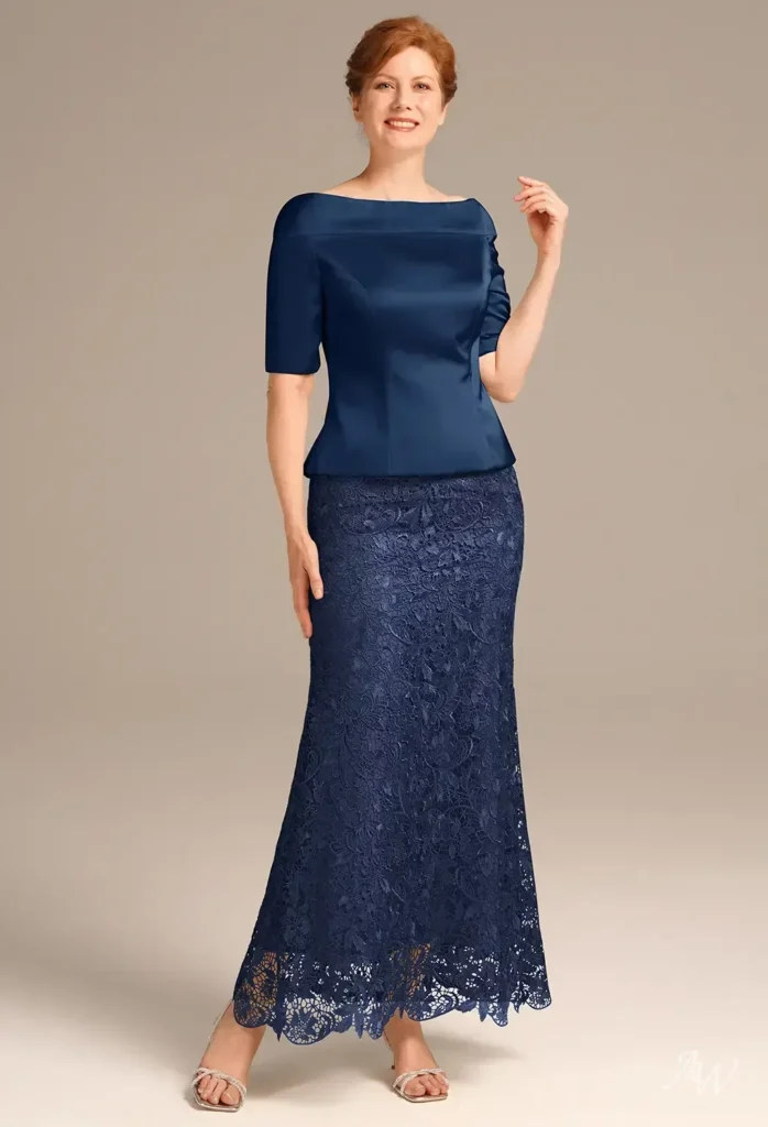 Front-facing full view of a model wearing the AW Penrose Dress in navy, highlighting an ankle-length mermaid silhouette, straight neckline, and intricate lace skirt detailing for formal wedding events.