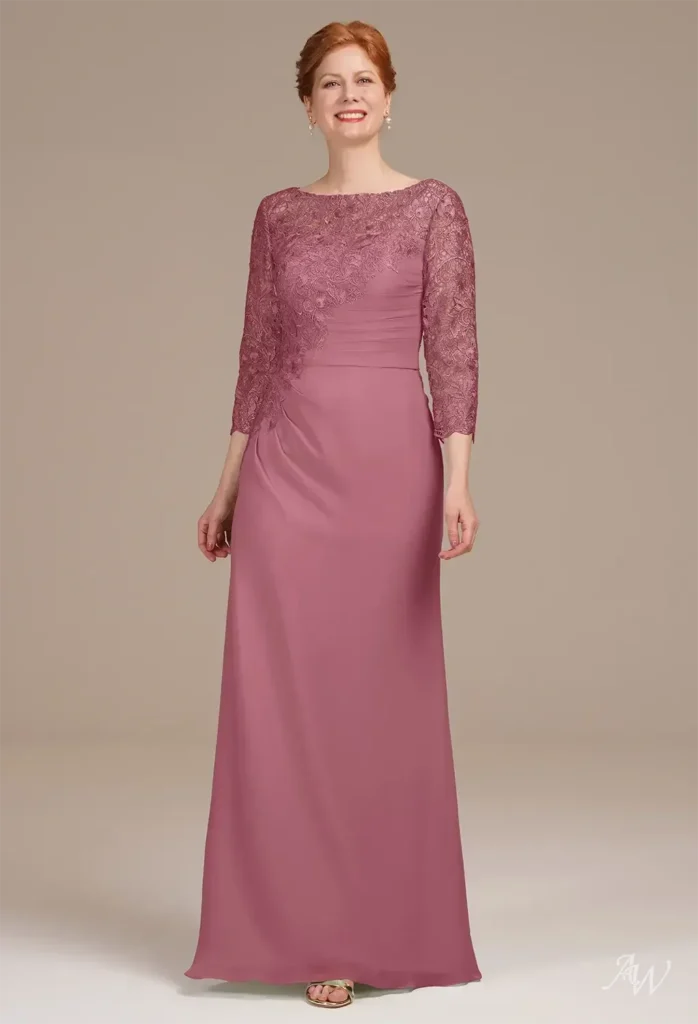 Full-length front shot of a proud mother wearing the AW Zephyr Dress featuring a floor-length mermaid silhouette, delicate lace sleeves, and rich burgundy fabric tailored for wedding celebrations.