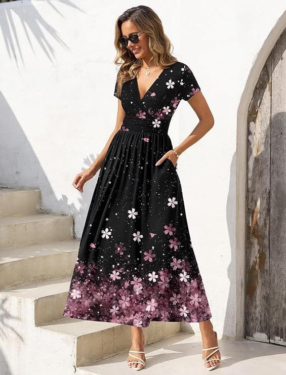 Full-length view of a model wearing a black floral print short-sleeve wrap maxi dress with an empire waist and side pockets, highlighting an attractive dress under $50 ideal for casual summer and fall days.