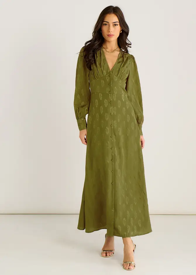 Full-length product image of a model wearing the Green Long Sleeve Floral Satin Jacquard Maxi Dress featuring long sleeves, a flowing maxi silhouette, and an intricate green floral satin jacquard weave, displayed against a neutral background to highlight its luxurious texture and elegant drape.