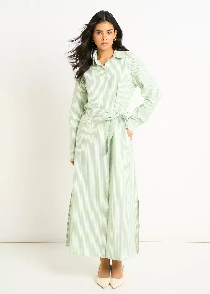 Full-length product image of a model wearing the Green Long Sleeves Seersucker Stripe Shirt Dress featuring long sleeves, a crisp seersucker stripe pattern, and a button-through design, displayed against a neutral background to highlight its lightweight texture and casual wear appeal. Long sleeve midi dress, green seersucker stripe shirt dress, UK fashion sales, comfortable casual dresses for women, stylish stripe shirt dresses, affordable UK clothing trends.