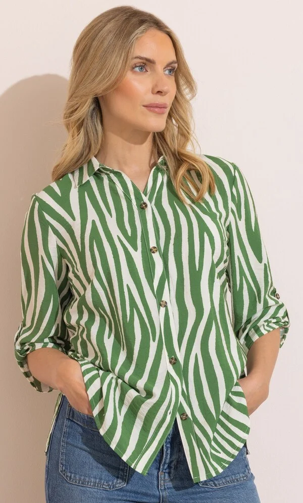 The Perfect Office Capsule Wardrobe: 2026 Work Essentials Guide 20 Studio shot of a model wearing the Klass khaki and white zebra print button-down blouse with a collared neckline and three-quarter sleeves, styled for a 2026 office capsule wardrobe.