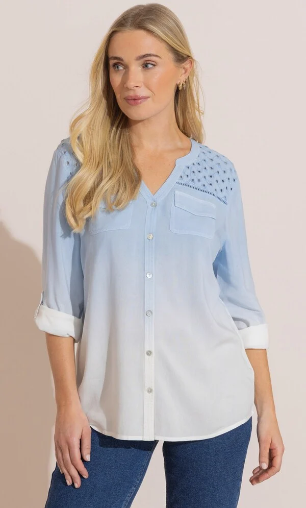 The Perfect Office Capsule Wardrobe: 2026 Work Essentials Guide 21 Studio portrait of a model wearing the Klass pale blue eyelet detail ombre dip dye blouse featuring a V-neckline, chest pockets, and shoulder embroidery, styled for an office capsule wardrobe.