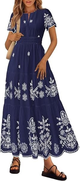 How to Style a Party Dress: Best Looks for Any Occasion 3 A model wearing a navy blue and white floral tiered boho maxi dress with short sleeves and a V-neckline, optimized for summer wedding guests and vacation fashion shopping