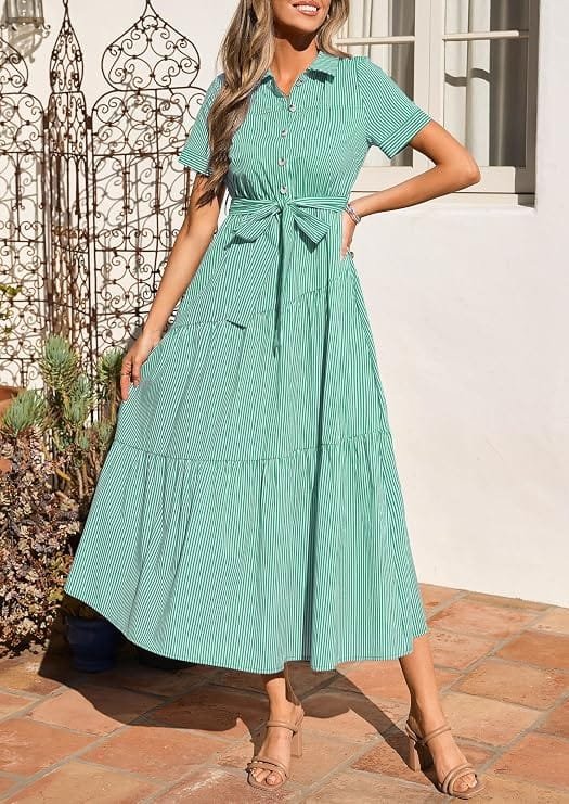 Full-length view of a model wearing a green and white vertical-striped short-sleeve maxi shirt dress with a collared V-neck, button-down front, and belted waist, highlighting a trendy dress under $50 ideal for professional workwear and summer days.