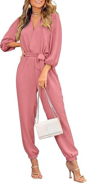How to Style a Party Dress: Best Looks for Any Occasion 10 Full-length view of a model wearing the PRETTYGARDEN pink long-sleeve wrap jumpsuit featuring a V-neck, self-tie waist, and side pockets, styled for an elegant evening cocktail party.