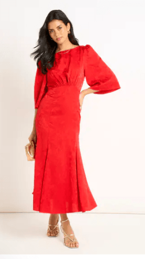 Best Midi Dresses Under £60 for Summer 2026 9 A model wearing an elegant red satin jacquard midi dress from Gini London.
