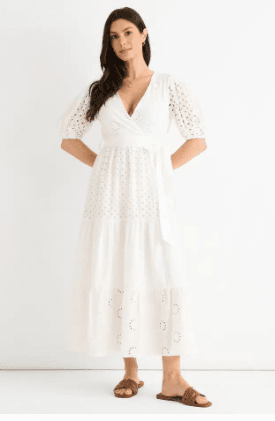 Best Midi Dresses Under £60 for Summer 2026 3 A model wearing a stylish white wrap broderie cotton belted midi dress from Gini London.