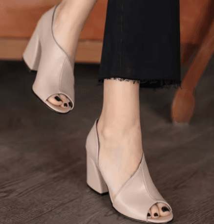 25 Minimalist Capsule Wardrobe Essentials 2026 | Timeless Pieces Every Woman Needs 13 A pair of stylish beige block-heel women's sandals with a fish-mouth open-toe design, showcased in a neutral color, perfect for a professional or casual 2026 summer outfit.