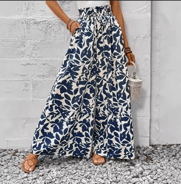 25 Minimalist Capsule Wardrobe Essentials 2026 | Timeless Pieces Every Woman Needs 19 A model wearing flowing, floral-printed draped culottes, styled as a key piece among seasonal capsule wardrobe essentials for a comfortable 2026 summer look.