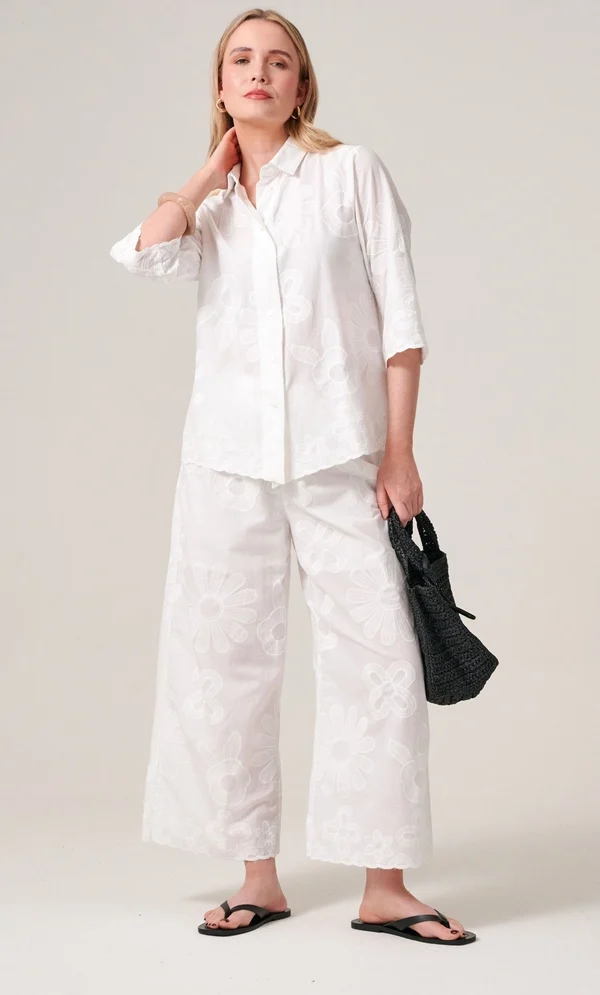 Business Casual Outfits for Women: 15 Best Work-Ready Looks for 2026 14 Business casual outfit for women featuring an embroidered white button-down shirt and matching wide-leg cropped trousers, styled for office and everyday professional wear.