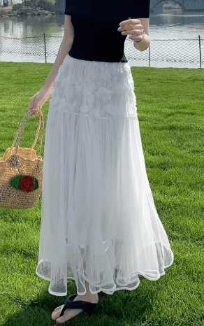 25 Minimalist Capsule Wardrobe Essentials 2026 | Timeless Pieces Every Woman Needs 23 A woman wearing an elegant high-waist A-line skirt with a 3D rose floral mesh overlay, a key piece for a sophisticated 2026 capsule wardrobe.