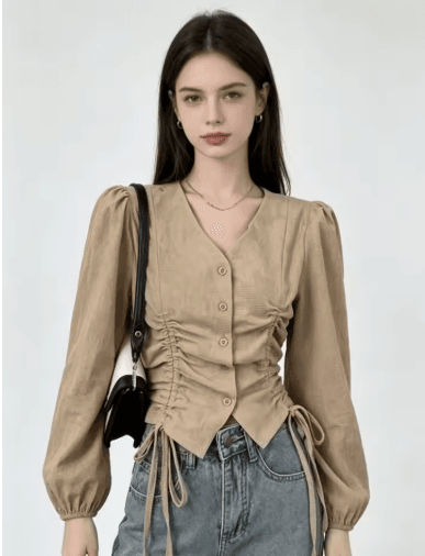 25 Minimalist Capsule Wardrobe Essentials 2026 | Timeless Pieces Every Woman Needs 8 A model wearing an elegant, oversized khaki V-neck blouse with long sleeves, styled in a minimalist, professional outfit perfect for a 2026 fashion aesthetic.