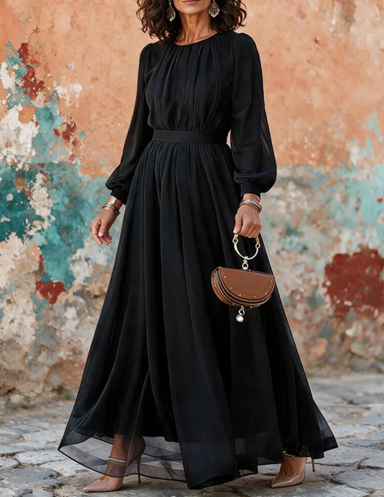 Trendy & Affordable Outfits for Women You'll Actually Love (2026) 8 A stylish woman wearing an affordable black long-sleeve chiffon maxi dress with a pleated skirt and elastic-waist bodice, styled for a formal evening look featuring Trendy Outfits for Women.