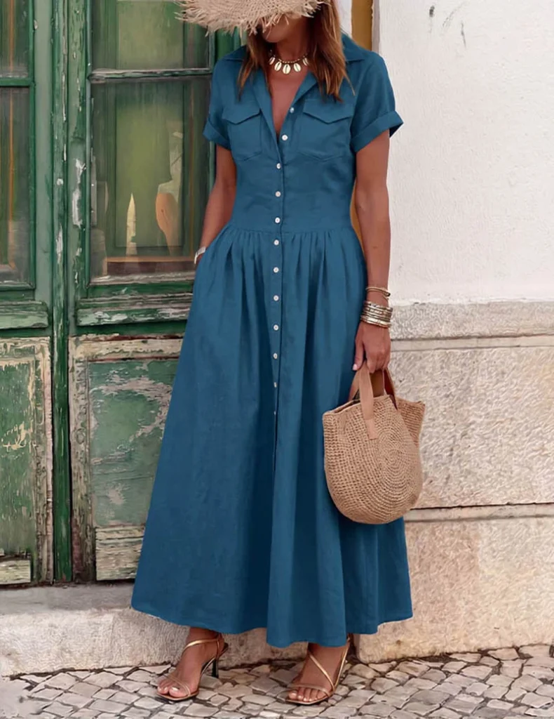 Trendy & Affordable Outfits for Women You'll Actually Love (2026) 3 A stylish woman wearing an affordable blue button-down maxi shirt dress with short sleeves and a flared hem, styled with sandals and a straw bag for an everyday summer look.