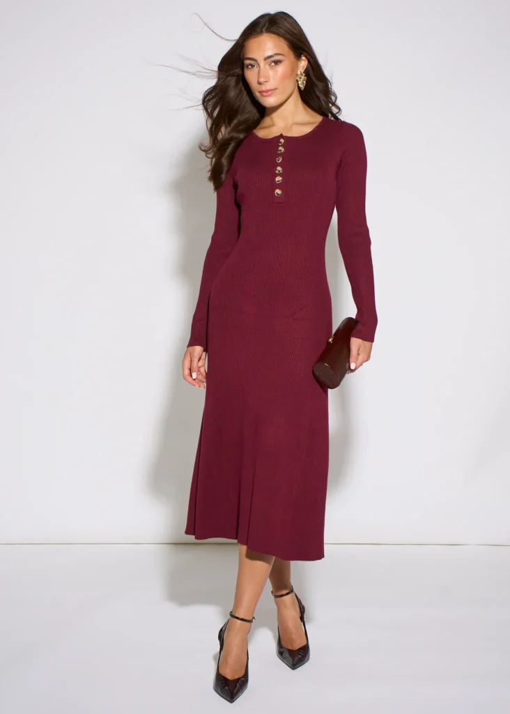 Trendy & Affordable Outfits for Women You'll Actually Love (2026) 13 A stylish woman wearing an affordable long-sleeve mulberry-colored midi dress featuring gold button details, styled for a chic everyday look showcasing Trendy Outfits for Women.